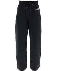 Versace - Pantalones de jogger angustiados con bordado del logotipo - Lyst