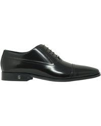 Versace Zapatos marrones de cuero Oxford de - Negro
