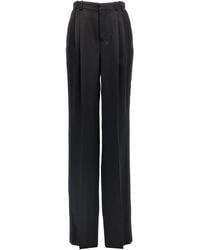 Saint Laurent - Pantalones de satén de - Lyst