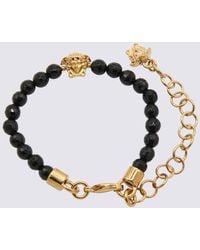 Versace - Black And Gold Metal Bracelets - Lyst
