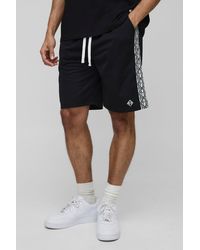 BoohooMAN - Lockere mittellange Shorts mit Logo-Streifen - Lyst