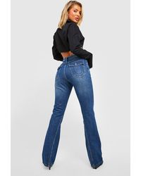 Boohoo - Mid Rise Twisted Seam Cargo Pocket Flared Jeans - Lyst