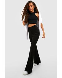 Boohoo Tall Wet Look Ruched Bum Flare Pants in Black