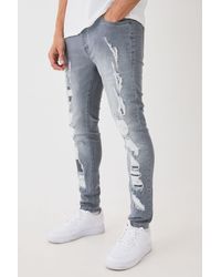 BoohooMAN - Skinny Stretch All Over Ripped Grey Jeans - Lyst