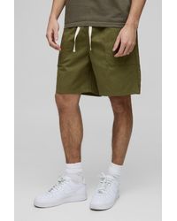 BoohooMAN - Elastische Lockere Twill-Shorts mit geteiltem Saum - Lyst
