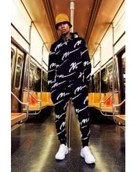 all over man printed hooded tracksuit black