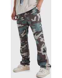 BoohooMAN - Tall Slim Stacked Gusset Flare Multi Cargo Camo Trouser - Lyst