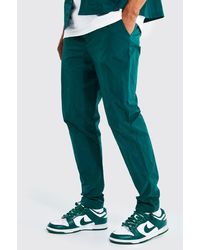 BoohooMAN Homme Vêtements Pantalons & Jeans Pantalons Cargos Pantalon chino à poches multiples et imprimé camouflage Homme 