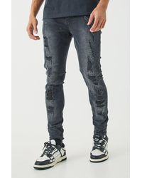 BoohooMAN - Skinny Stretch All Over Ripped Black Jeans - Lyst