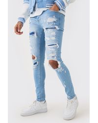 BoohooMAN - Skinny Stretch All Over Rip Bleached Denim Jean In Light Blue - Lyst