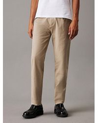 Calvin Klein - Pantalones plisados de sarga con corte Tapered - Lyst