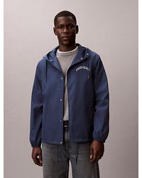 Calvin Klein - Coach Jas Met Grafisch Logo En Capuchon - Lyst