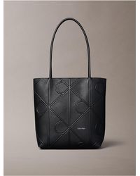 Calvin Klein - Embossed Allover Monogram Logo Small Tote Bag - Lyst