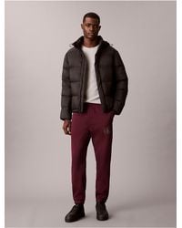 Calvin Klein - Calvin Klein Fleece Layered Monogram Graphic Sweatpants - Lyst