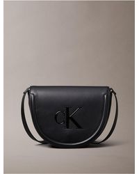Calvin Klein - Embossed Monogram Logo Saddle Bag - Lyst