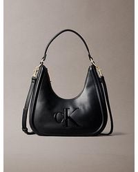 Calvin Klein - Embossed Monogram Crescent Bag - Lyst