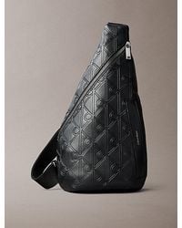 Calvin Klein - Debossed Allover Emblem Logo Sling Bag - Lyst