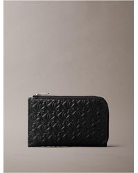 Calvin Klein - Calvin Klein Embossed Allover Monogram Zip Wallet - Lyst