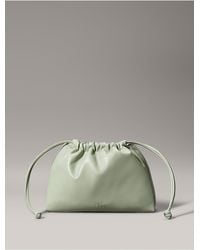 Calvin Klein - Calvin Klein Monogram Logo Drawstring Crossbody Bag - Lyst