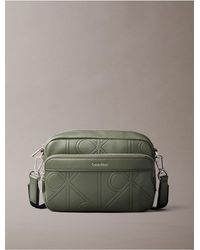 Calvin Klein - Allover Embossed Emblem Logo Camera Bag - Lyst