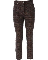 Moschino - Logo-jacquard Tapered-leg Mid-rise Jeans - Lyst