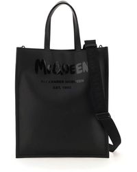 Save 13% Alexander McQueen Leather Graffiti Logo Printed Tote Bag in Black for Men Mens Bags Tote bags 