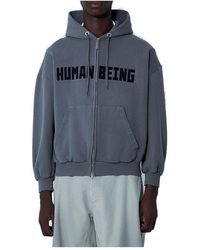 Balenciaga Zip-Up Human Being Hooded Sweatshirt in Blue Balenciaga Zip-Up Human Being Hooded Sweatshirt in Blue