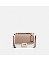 coach beat shoulder bag in colorblock with rivets