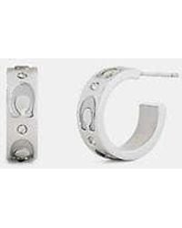 COACH - Repeated C Huggie Earrings - Lyst