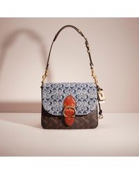 COACH®: Embossed Horse And Carriage Large Edie Shoulder Bag In Pebble  Leather