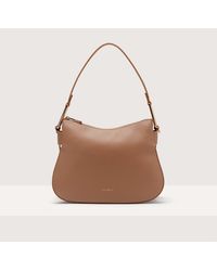 Coccinelle - Grained Leather Shoulder Bag Magie Soft Small - Lyst