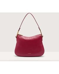 Coccinelle - Grained Leather Shoulder Bag Magie Soft Small - Lyst