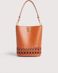 Coccinelle - Smooth Cowhide-Effect Leather Bucket Bag With Broderie Anglaise Monogram Detailing Nikla Medium - Lyst