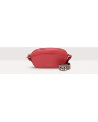 Coccinelle - Minibag aus genarbtem Leder Enchanteuse - Lyst
