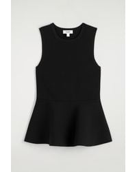 COS - Knitted Peplum Top - Lyst