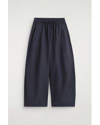 COS - Elasticated Barrel-leg Trousers - Lyst