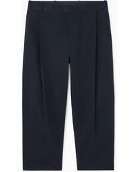 COS - Pleated Tapered Pants - Lyst
