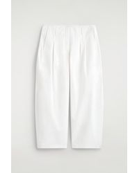 COS - Pleated Cotton Balloon-Leg Trousers - Lyst