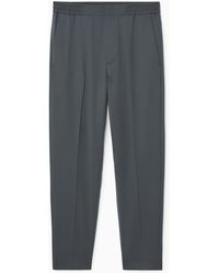 COS - Tapered Elasticated Wool-twill Trousers - Lyst