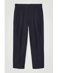 COS - Relaxed Pleated Cotton Tapered Trousers - Lyst