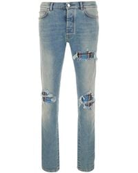 Amiri - Light Jeans With Ripped Details And Faded Design - Lyst
