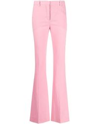 Versace - All Over Logo Flared Trousers - Lyst