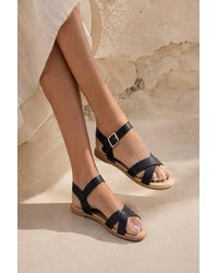 LARANGE - Cross Strap Buckle Flat Sandals - Lyst