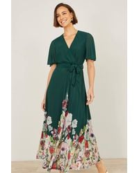 Yumi' - Mesh Wrap Midi Dress With Floral Hem Border - Lyst