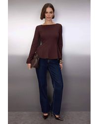WOVCOR - Boat Neck Peplum Long Sleeve Knit Blouse - Lyst