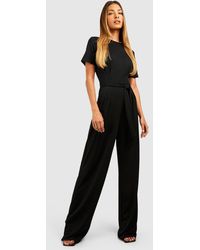 Boohoo - Crepe Pleat Front Belted Wide Leg Jumpsuit - Lyst