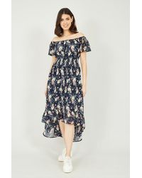 Mela - Navy Tropical Printed Dipped Hem Bardot Dress - Lyst