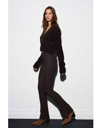 Dilvin - High-Waist Flare Leggings With Button Hem Detail - Lyst