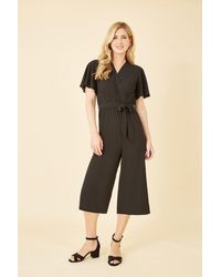 Mela - Black Wrap Over Jumpsuit With Angel Sleeve - Lyst