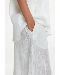 delos.land - Clement Trousers Silk Pintuck - Lyst